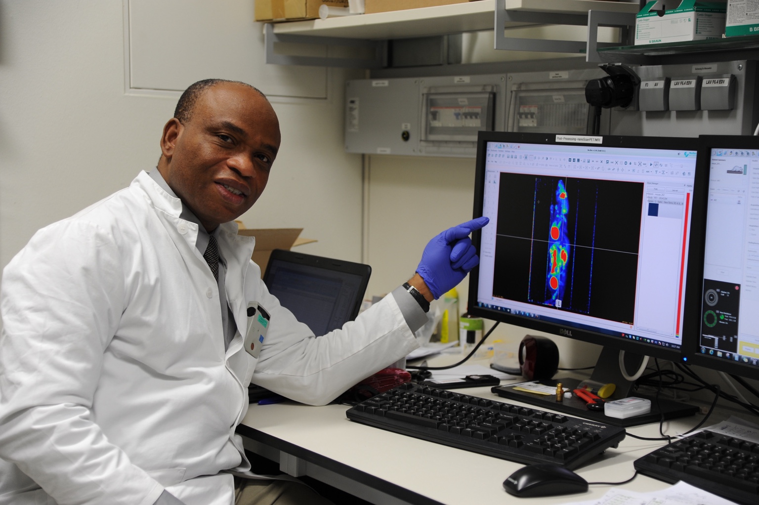 Dr Philip Njemanze at a computer displaying medical imaging data.